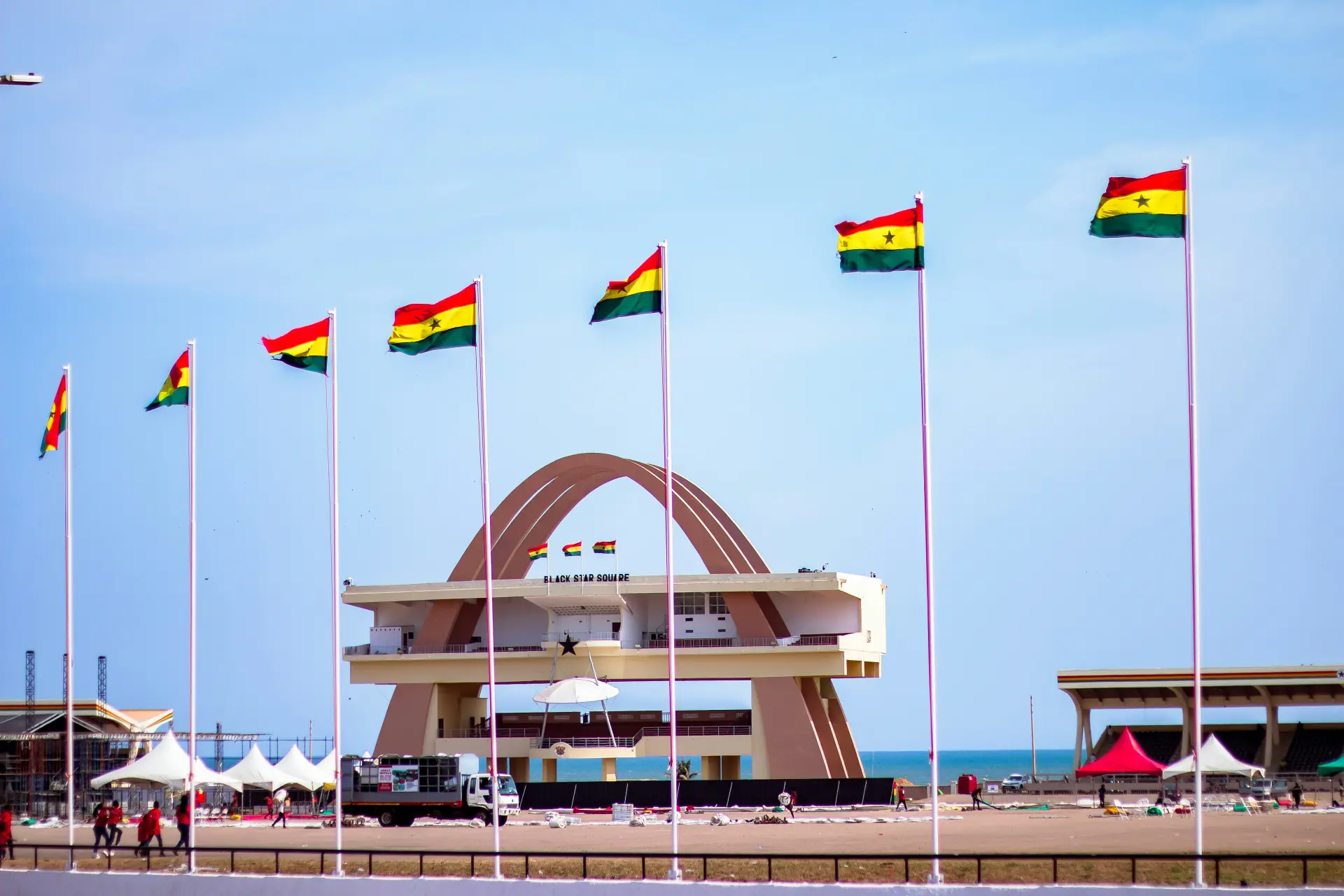 Bustling Accra cityscape at sunset with modern buildings, vibrant streets, and coastal atmosphere reflecting the energy of Ghana's capital